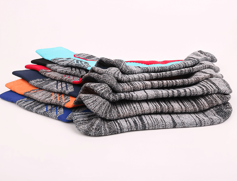 Stack of colorful Outdoor Sports Warm Skiing Socks, soft and thick for hiking, showcasing breathable and sweat-absorbent features